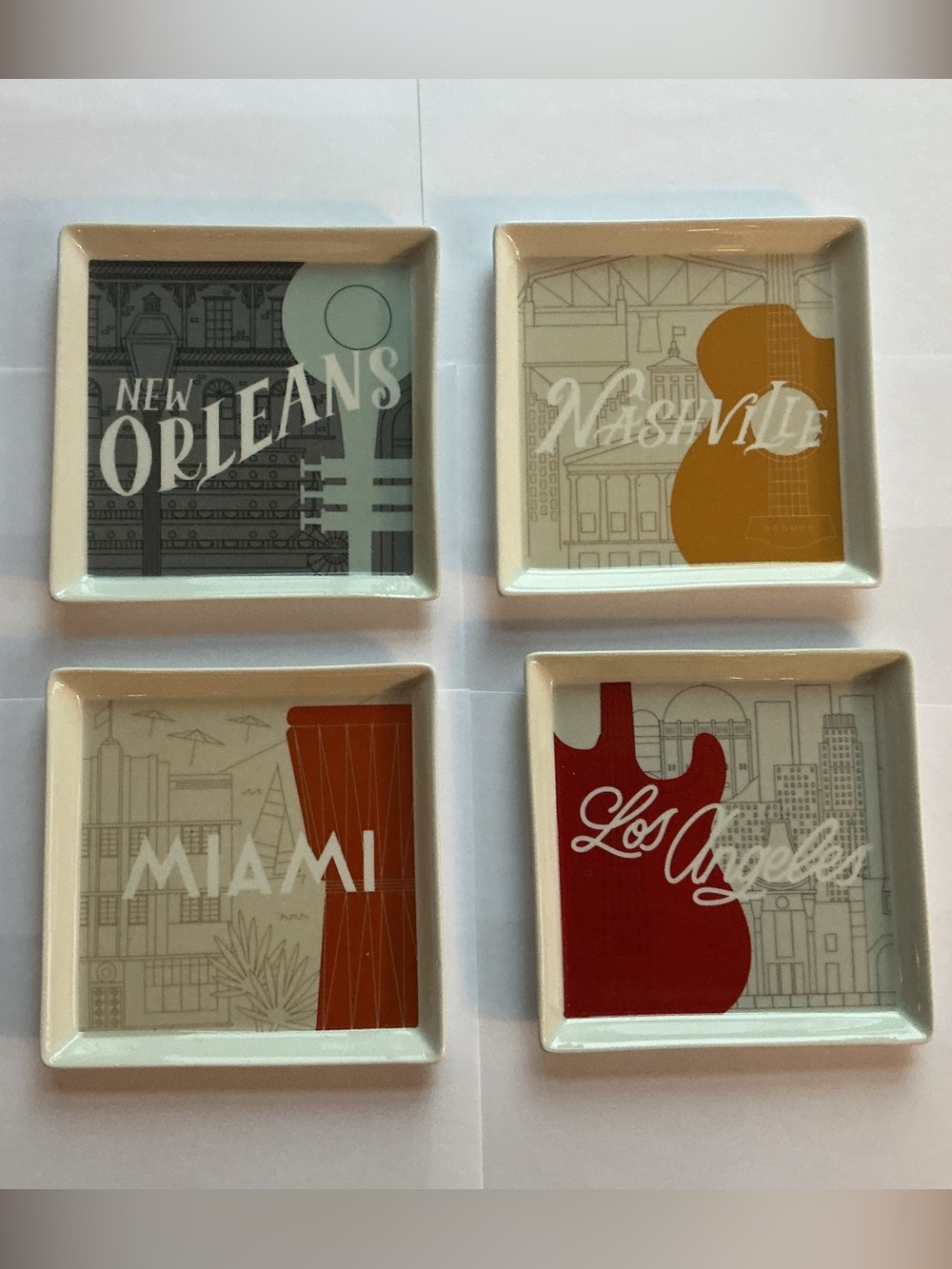 Set of Four Ceramic Appetizer Plates from the Crate & Barrel Music City Series.
